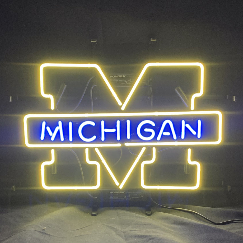 University of Michigan Logo Neon Sign illuminated in blue on metal grid backing