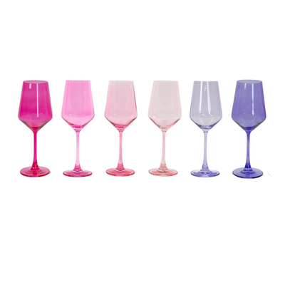 Set of six ombré colored wine glasses in shades of pink, red, and purple arranged on a surface