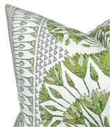 Close-up of a white pillow with a Cairo-inspired green and gray botanical and geometric pattern, featuring leaves and small triangle motifs.