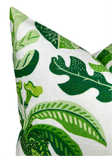 Corner of a leaf green pillow cover with various large tropical leaf patterns in shades of green on white fabric, highlighting detailed leaf veins and shapes.