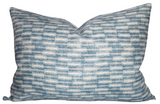 Rectangular pillow cover featuring a textured woven pattern in shades of blue and white with horizontal, staggered rectangular motifs.