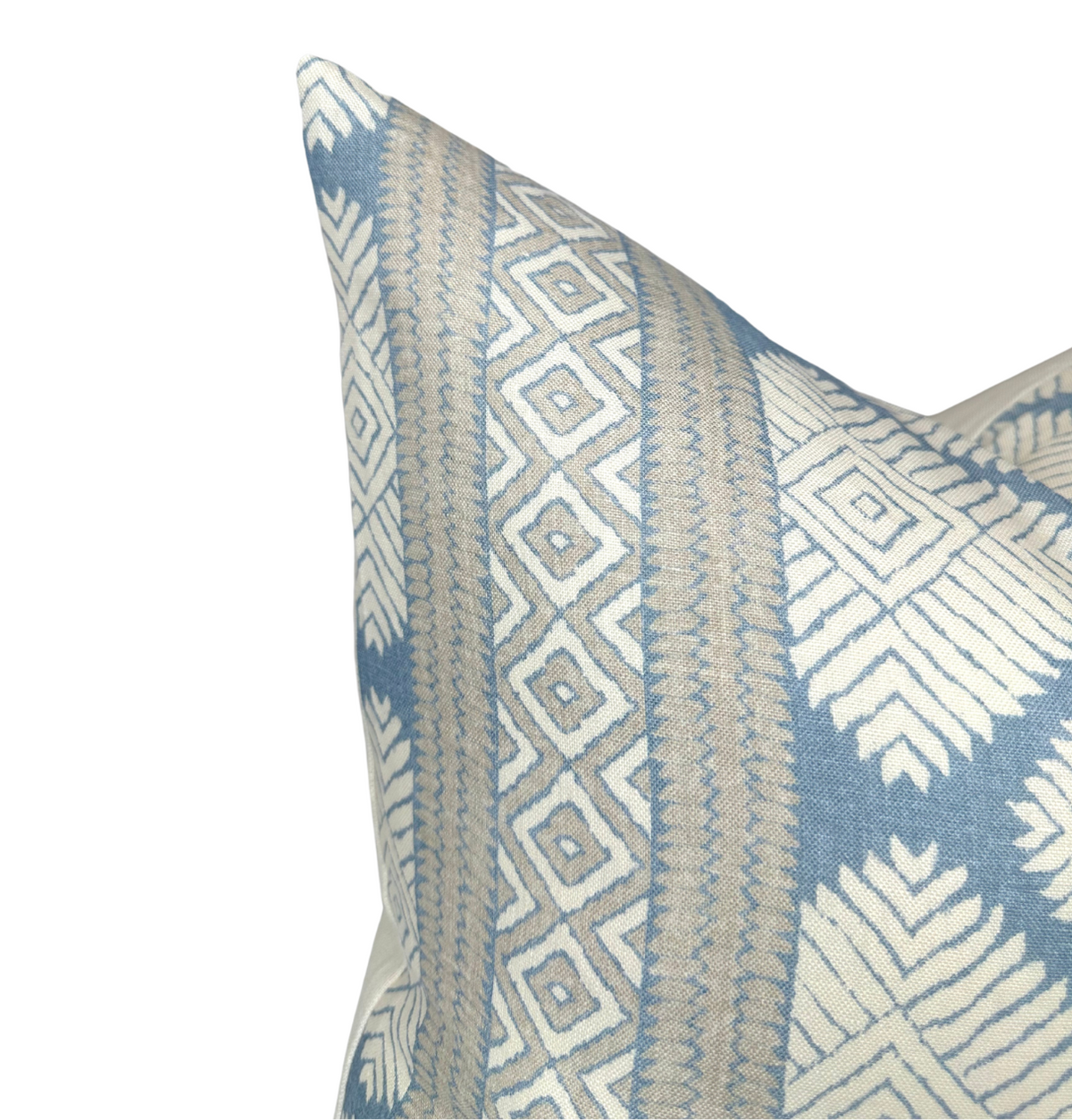 Close-up of a blue and beige pillow cover with geometric diamond and arrowhead patterns on a white background.