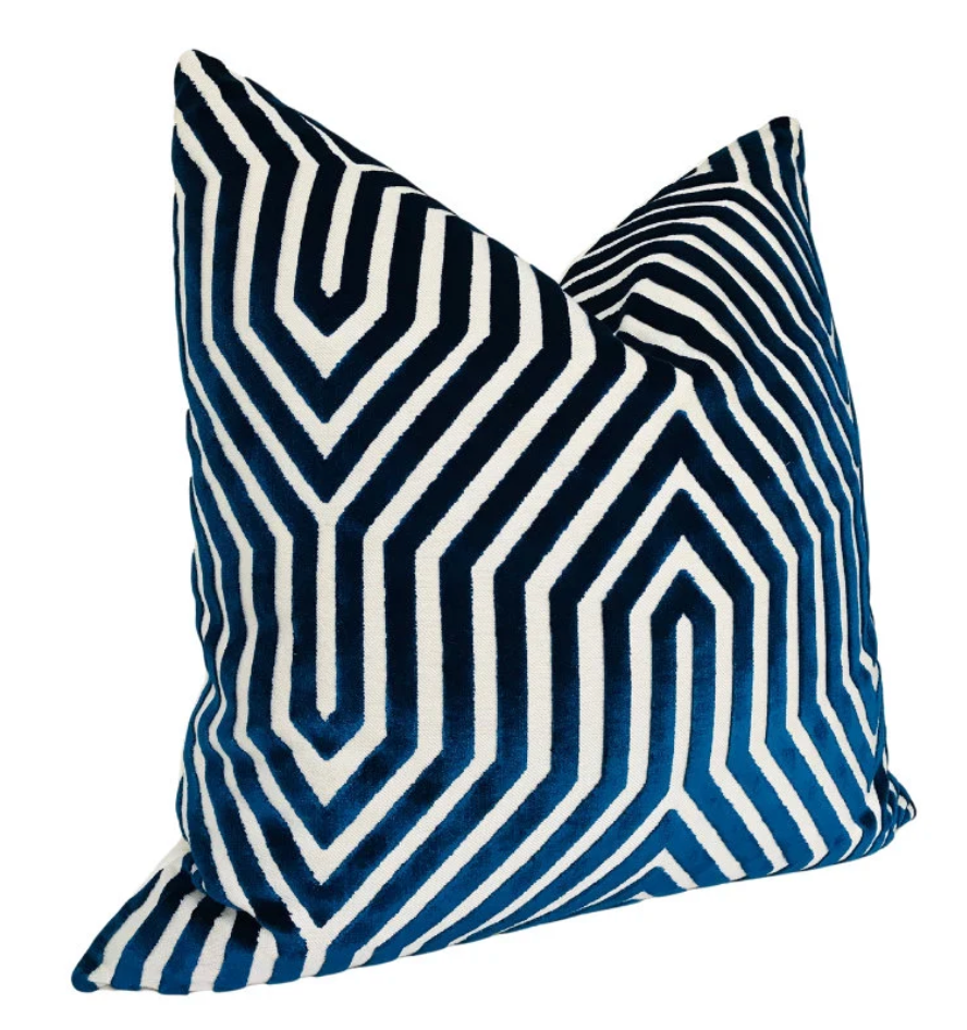 Square velvet pillow cover with navy blue and white geometric maze-like pattern, showcasing a soft and plush texture in a slightly angled view.
