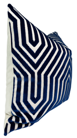 Square navy blue velvet pillow cover with bold white geometric maze-like pattern, shown at an angle against a plain white background.
