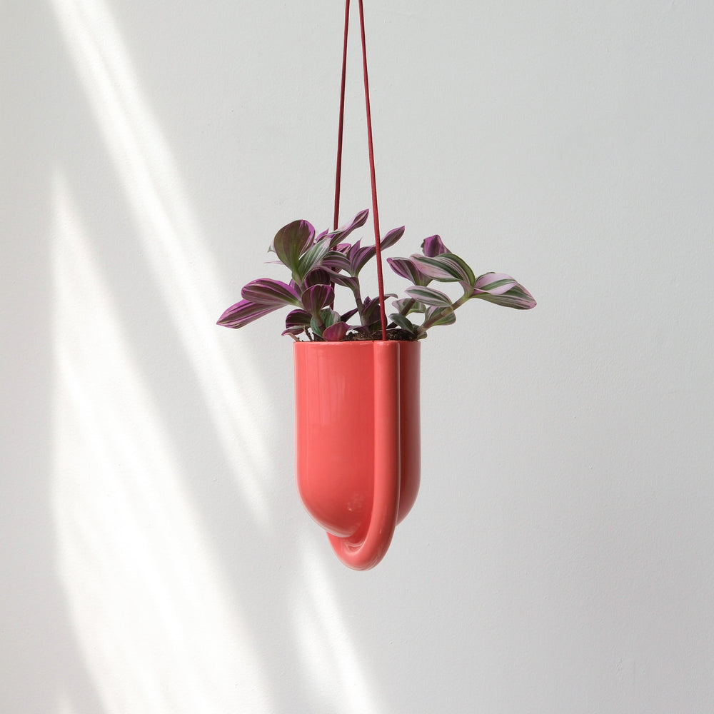 Portico Planter in Vermilion color shown hanging, minimalist ceramic design with integrated drainage