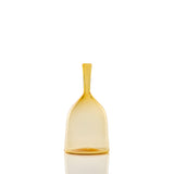 Transparent amber bottle with a wide, rounded base tapering upward to a narrow, elongated neck with a flared rim, shown upright on a white reflective surface.