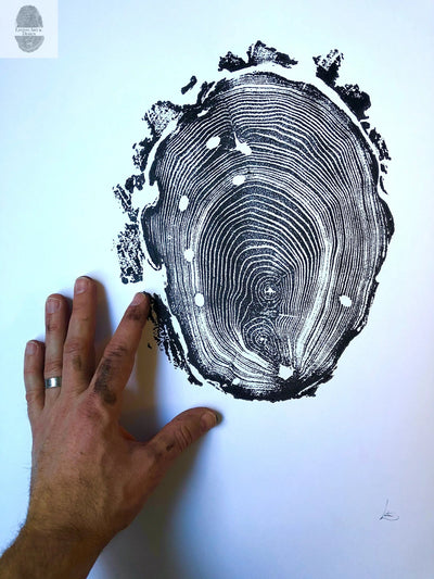 Walden Pond Print showing an 18x24 locust tree ring woodcut artwork by Erik Linton