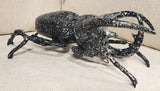 Golden Atlas Beetle wall decoration by DEKOR displayed against a white wall