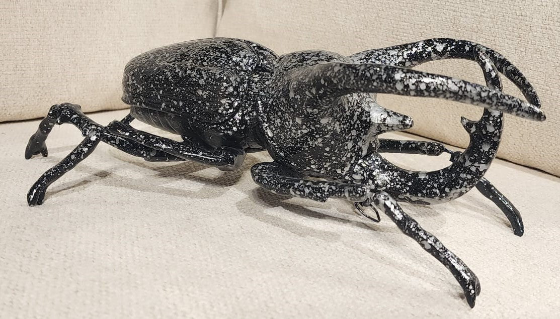 Golden Atlas Beetle wall decoration by DEKOR displayed against a white wall