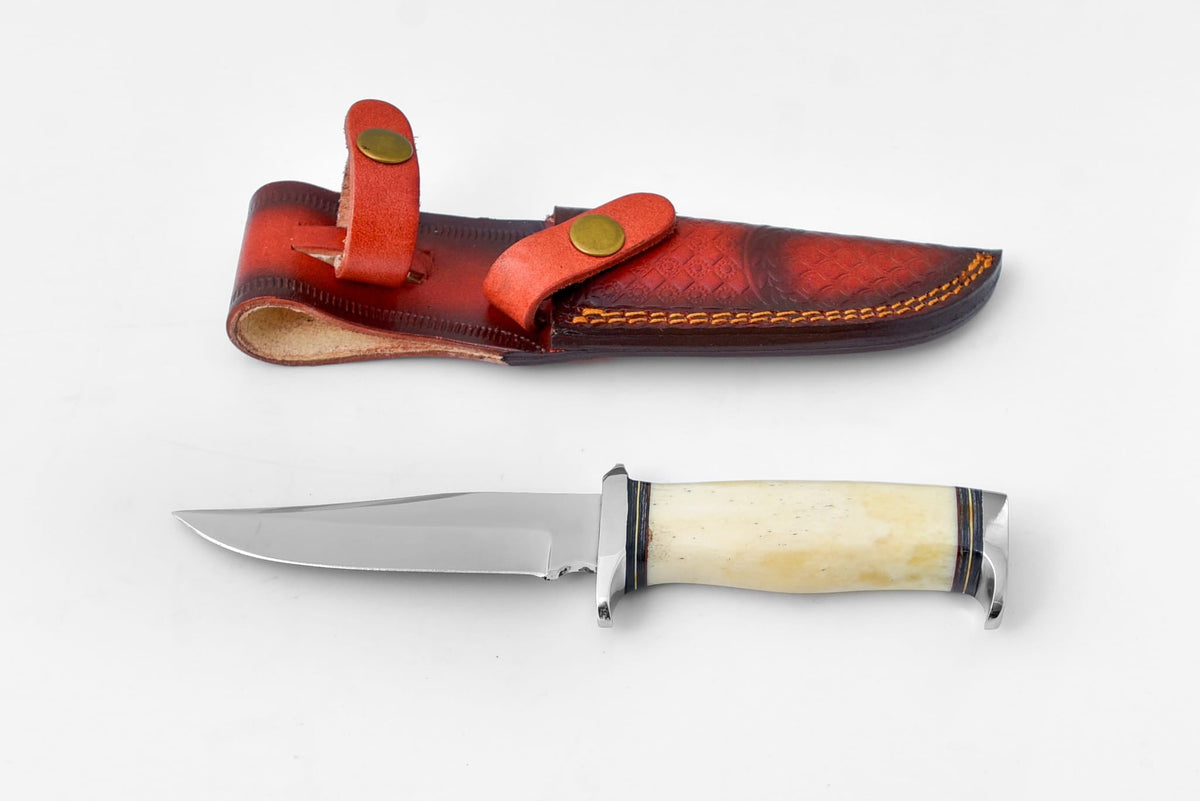 Titan Expedition Hunting Blade - TO-001 with leather sheath on wooden surface