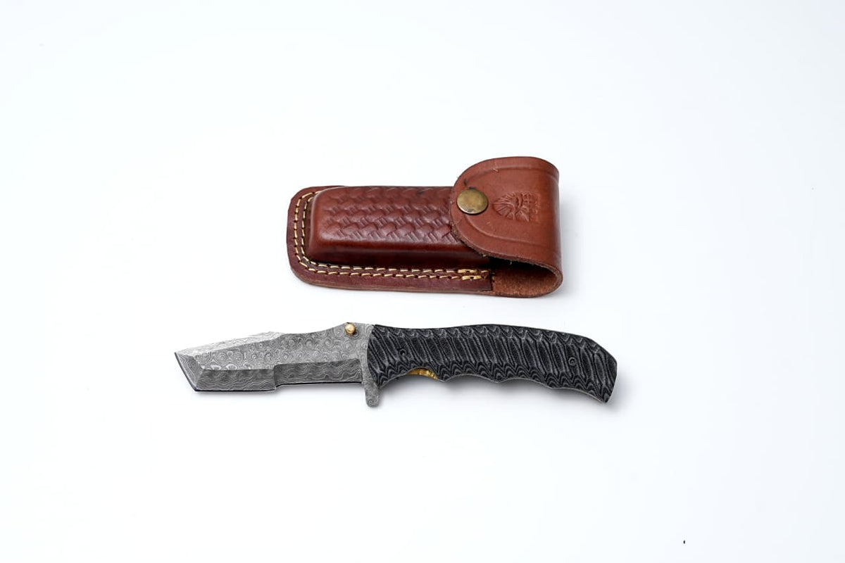 Storm Edge – Damascus Folding Blade - TF-082 showing folded Tanto-style blade and textured black micarta handle with brass accents
