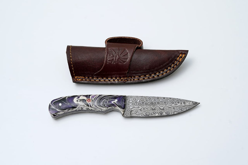 Damascus Steel EDC Knife with stabilized acrylic handle and raindrop-pattern blade resting on wood surface