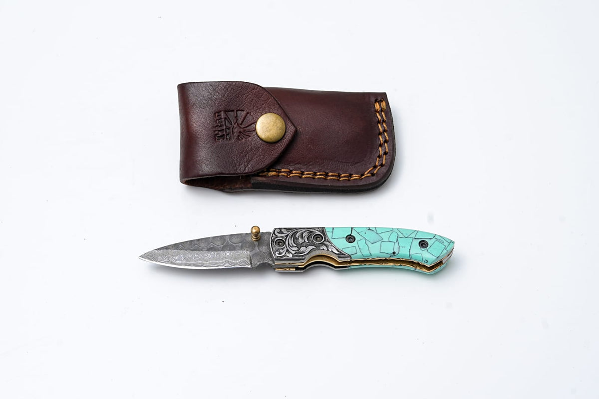 Turquoise Damascus Folding Knife – Hand Engraved Bolster Edition showing blade, turquoise handle inlay, and hand-engraved bolsters