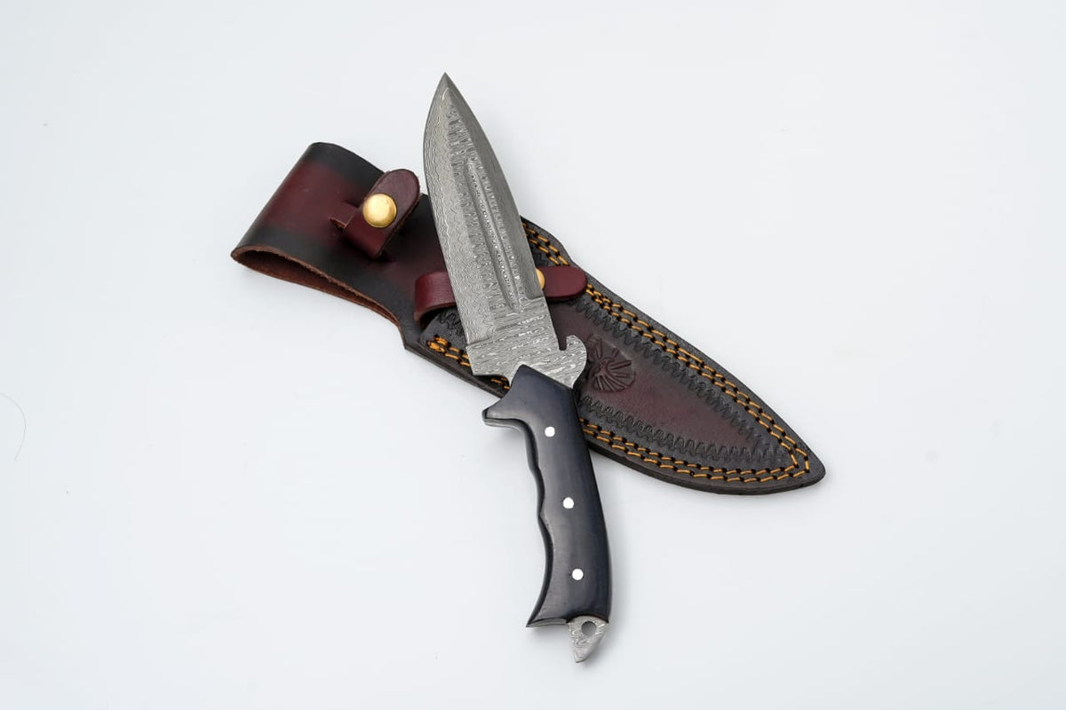 TD-018 fixed blade knife by Titan International K with Damascus steel blade and Micarta handle on black and wooden backgrounds