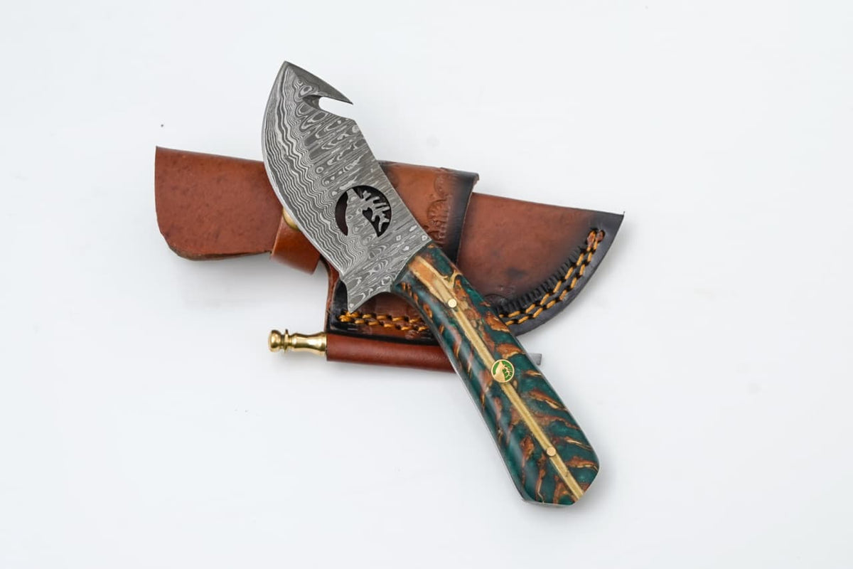Damascus Guthook Hunting Knife with pine cone handle - TK- 423 laying on a white surface