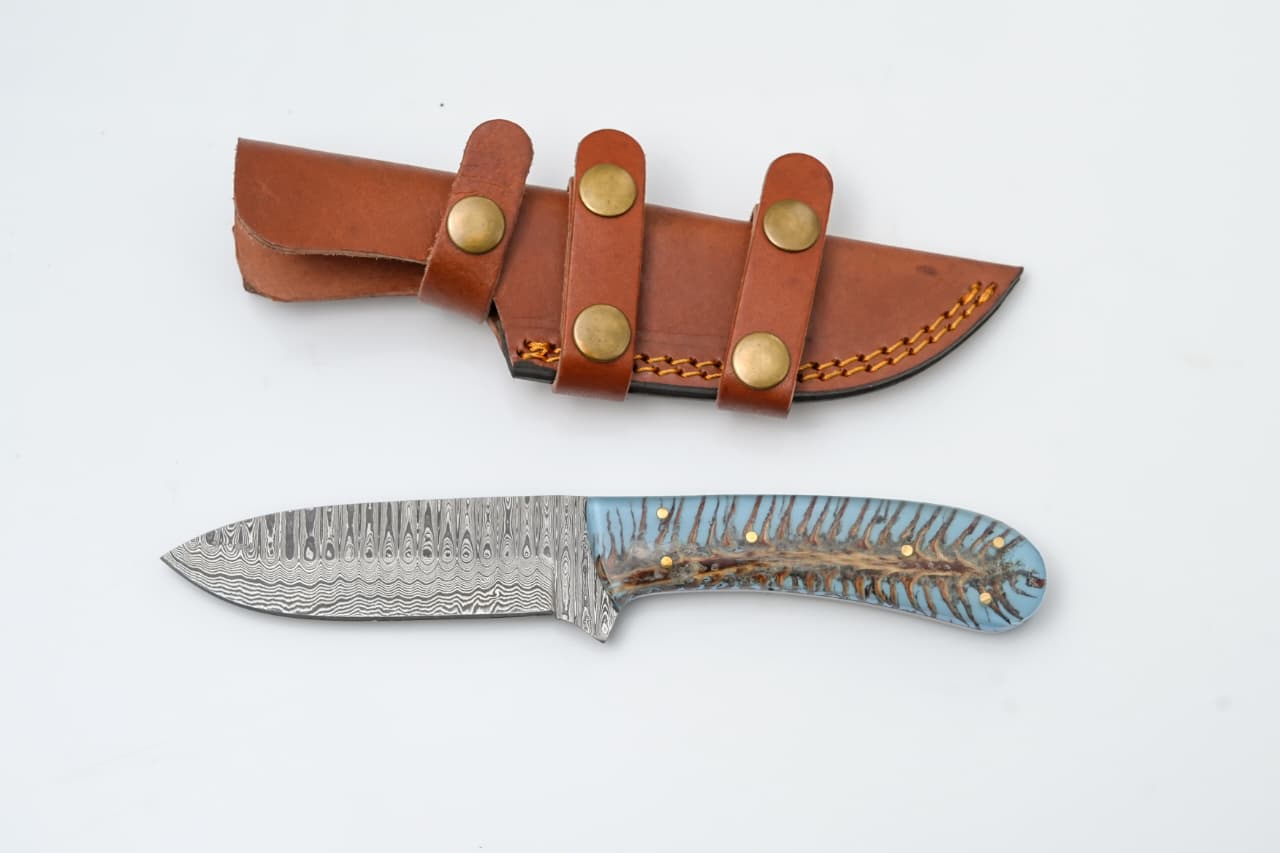 Custom Damascus Steel Knife with Blue Resin & Bone Handle - TK-425 displaying patterned blade and blue resin handle alongside leather sheath