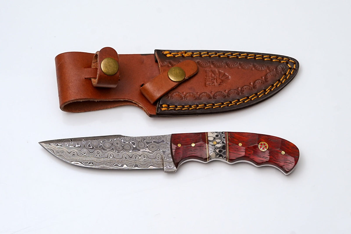 Crimson Mirage Titan Limited Series hunting knife with Damascus steel blade and exotic crimson wood handle, displayed with leather sheath
