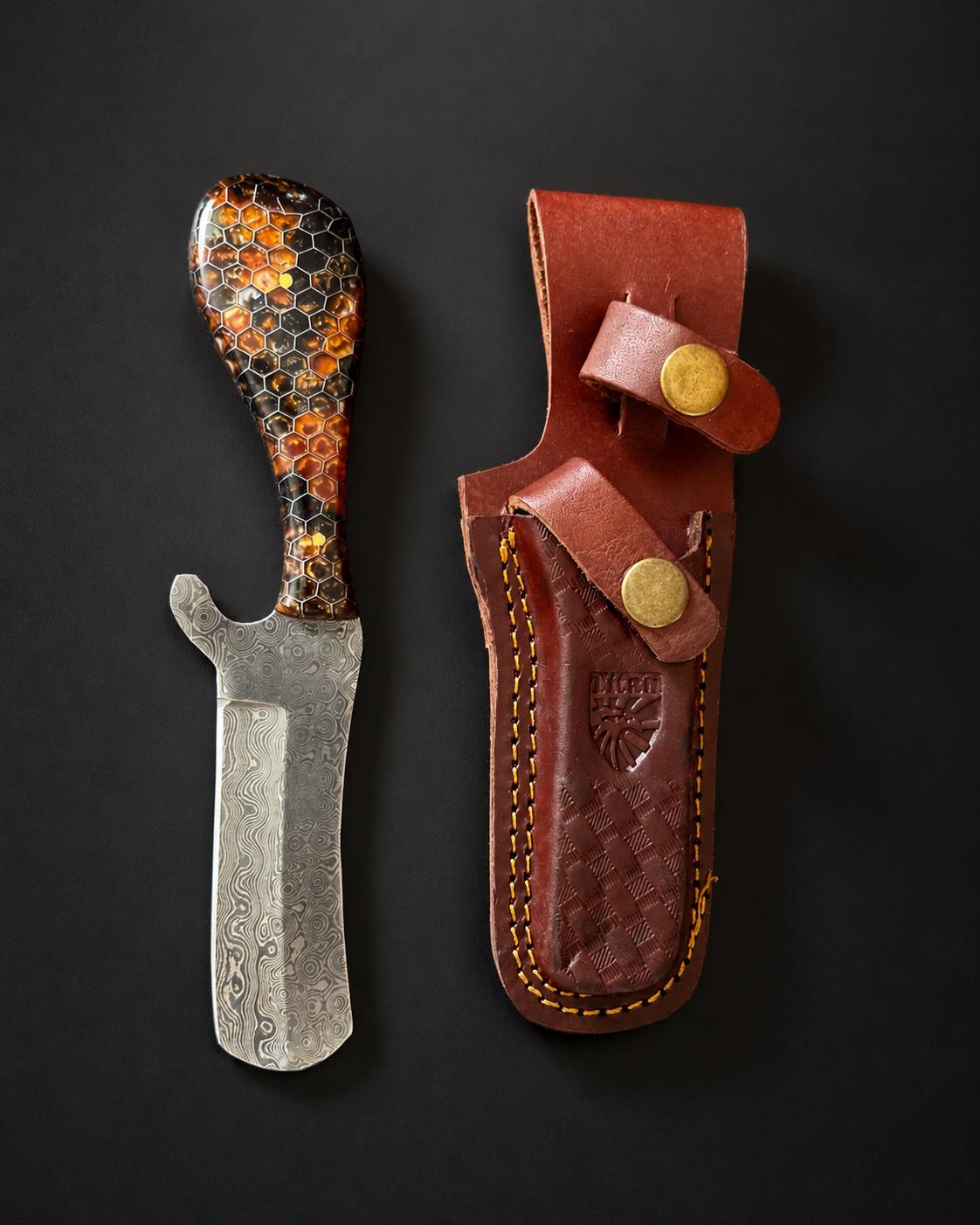 Titan Fossil Amber Hive Damascus Bull Cowboy Cutter knife with honeycomb resin handle and hand-tooled leather sheath