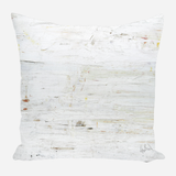 Square pillow with a textured white surface featuring subtle off-white, cream, and faint gray brushstrokes creating an abstract, weathered look.