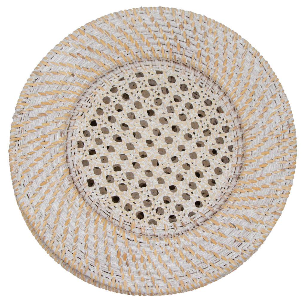 Set of four white rattan chargers arranged on a table with plates and tableware