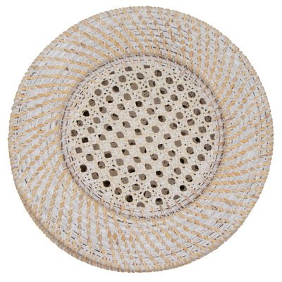 Set of four white rattan chargers arranged on a table with plates and tableware