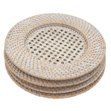 Stack of four round white rattan chargers with woven patterns and natural light tan accents, viewed at a slight angle showing their textured rims.