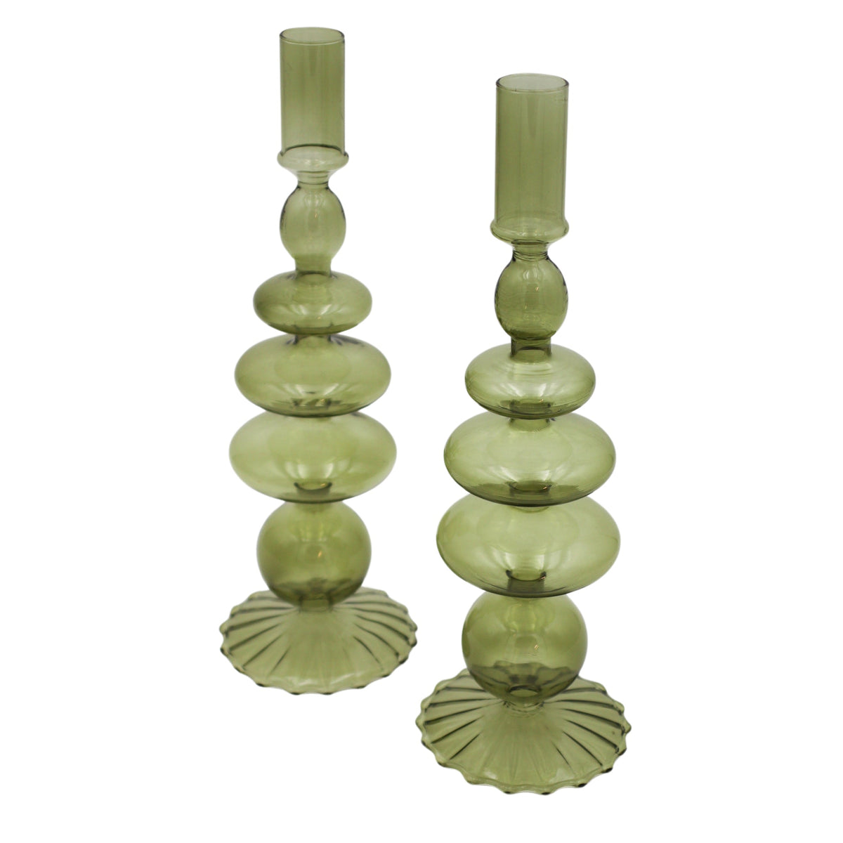Pair of translucent green glass candle holders with stacked rounded shapes and fluted circular bases seen from a slight angle against a white background.