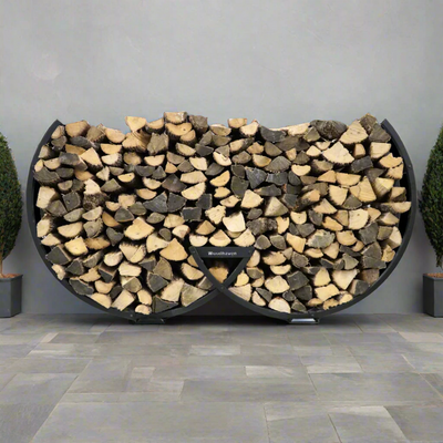 Winter Workman firewood rack by The Woodhaven showing curved steel design and wood storage