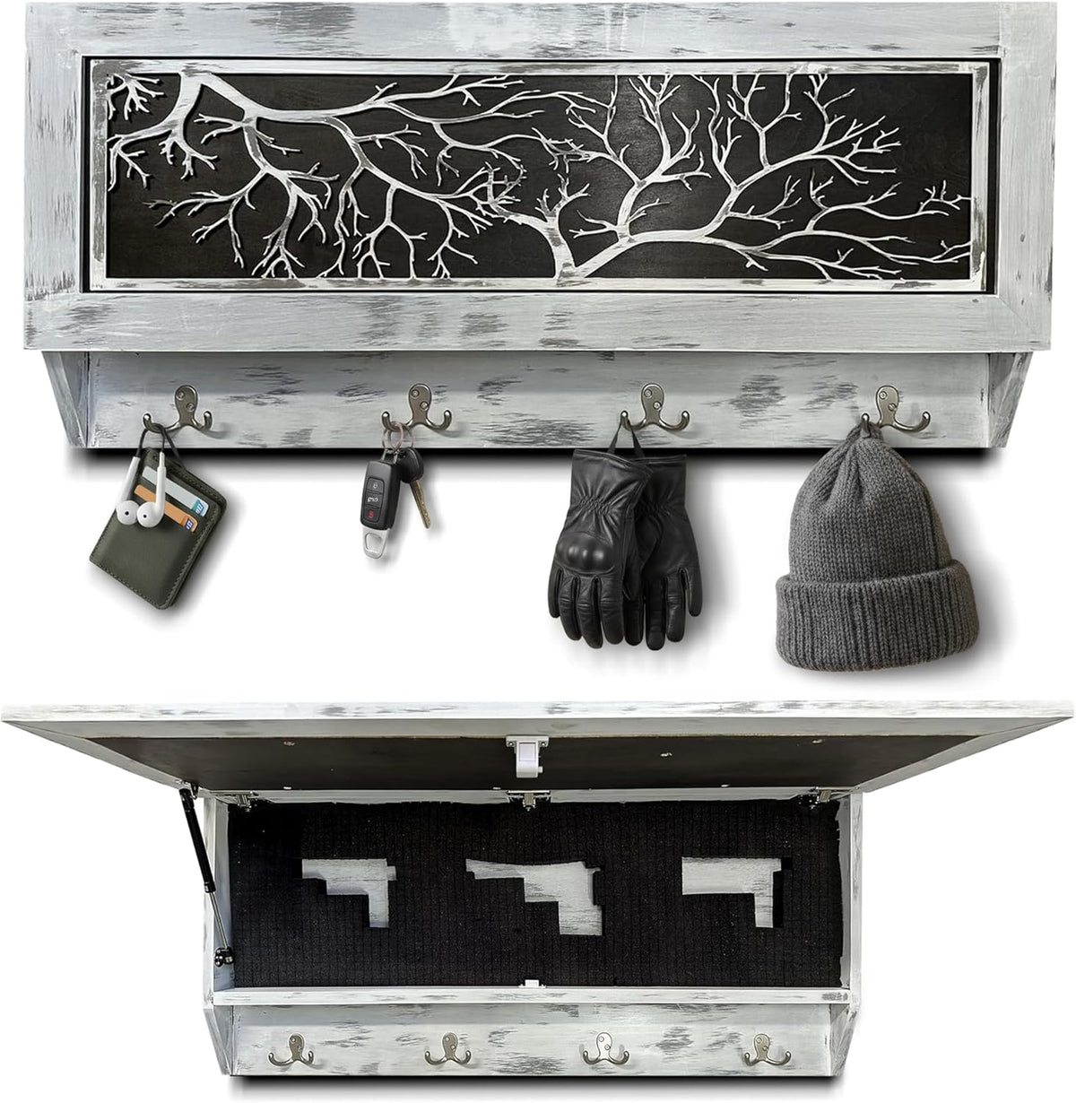 Rectangular wall-mounted wooden box with a whitewashed finish and a black panel featuring white tree branches, with four hooks holding keys, gloves, and a hat; the box opens to reveal a hidden compartment with three gun-shaped cut