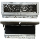 Rectangular rustic white wooden box with silver tree branch cutout on front, four metal hooks below, shown closed and open revealing black interior storage space.