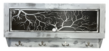 Rectangular wooden gun concealment decor with whitewashed finish, featuring a black panel cut into a bare winter tree silhouette and four metal hooks below.