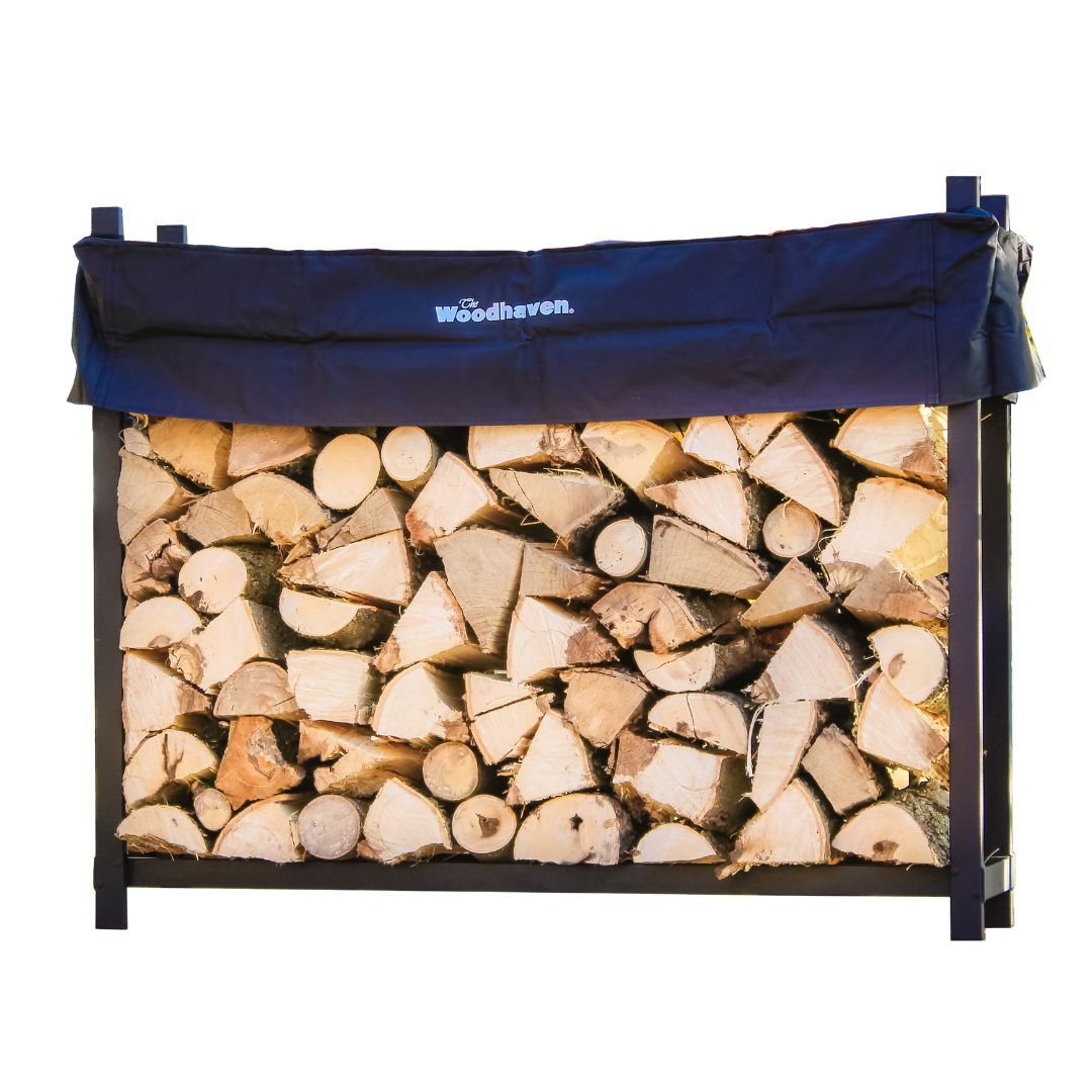 The Woodhaven 5 ft Firewood Rack in black showing stacked firewood on a patio