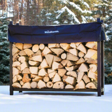 The Woodhaven 5 ft Firewood Rack in black showing stacked firewood on a patio