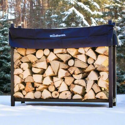 The Woodhaven 5 ft Firewood Rack in black showing stacked firewood on a patio