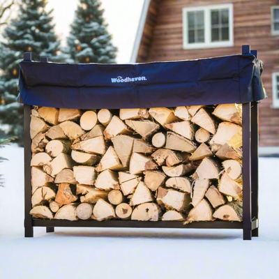 The Woodhaven 5 ft Firewood Rack in black showing stacked firewood on a patio