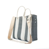 Rectangular woven crossbody bag with black and white vertical stripes and a beige adjustable strap with silver hardware, featuring two white rope handles.