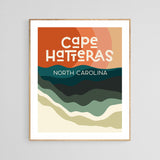 Modern art print with stylized layered waves in beige, green, and dark teal beneath a large burnt orange sun, text reading Cape Hatteras North Carolina in bold white letters