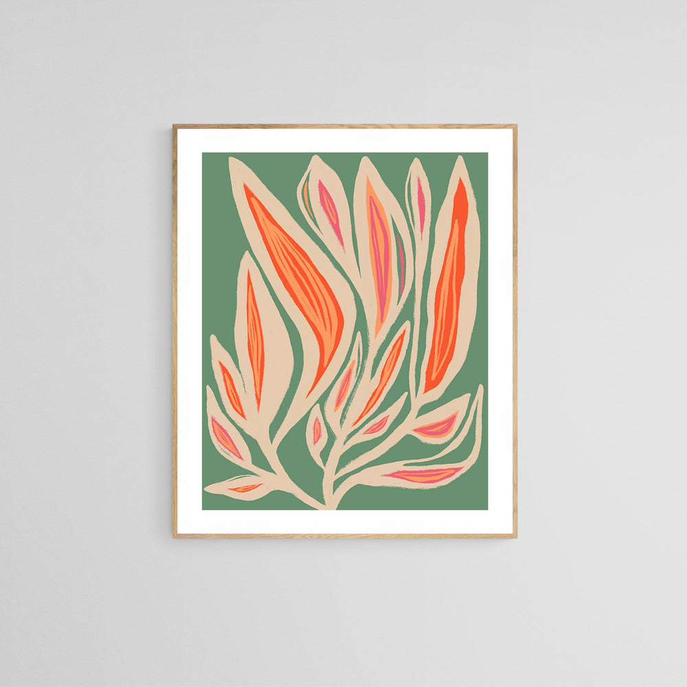 Abstract floral print with elongated beige and orange shapes over a muted sage green background, framed in light wood and set against a pale wall.