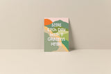 Note card with abstract shapes in green, orange, mustard, and cream colors, featuring white text that reads 'Start each day with a grateful heart' on a beige background.