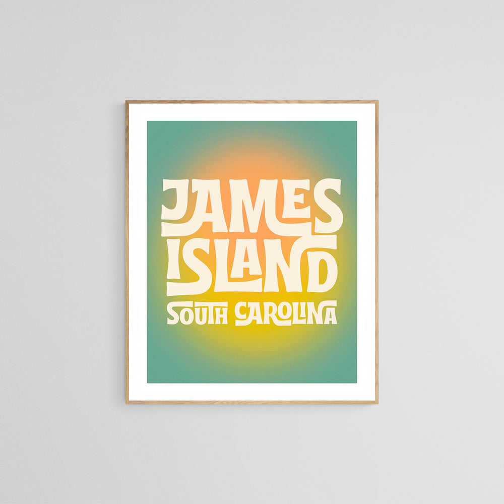 Modern art print with retro-style yellow and white text reading 'James Island South Carolina' on a gradient green to orange background framed in light wood.
