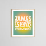 Modern art print with retro-style yellow and white text reading 'James Island South Carolina' on a gradient green to orange background framed in light wood.