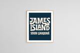 Framed modern art print with bold cream text reading 'JAMES ISLAND SOUTH CAROLINA' on a deep navy blue background, centered on a plain light gray wall.