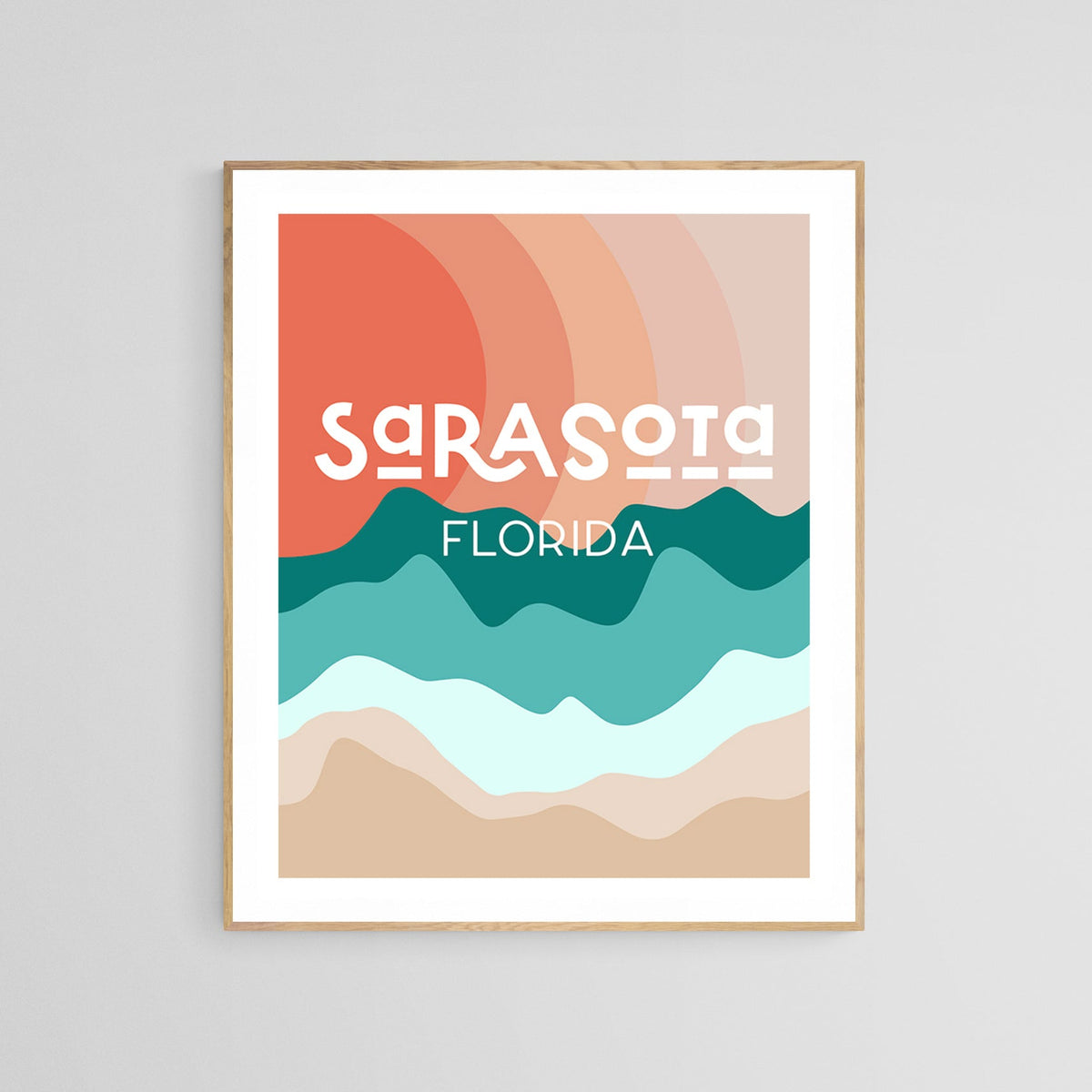 Modern art print with layered abstract waves in teal, turquoise, and beige under a stylized red sun, featuring the text 'Sarasota Florida' in white, framed and wall-mounted.