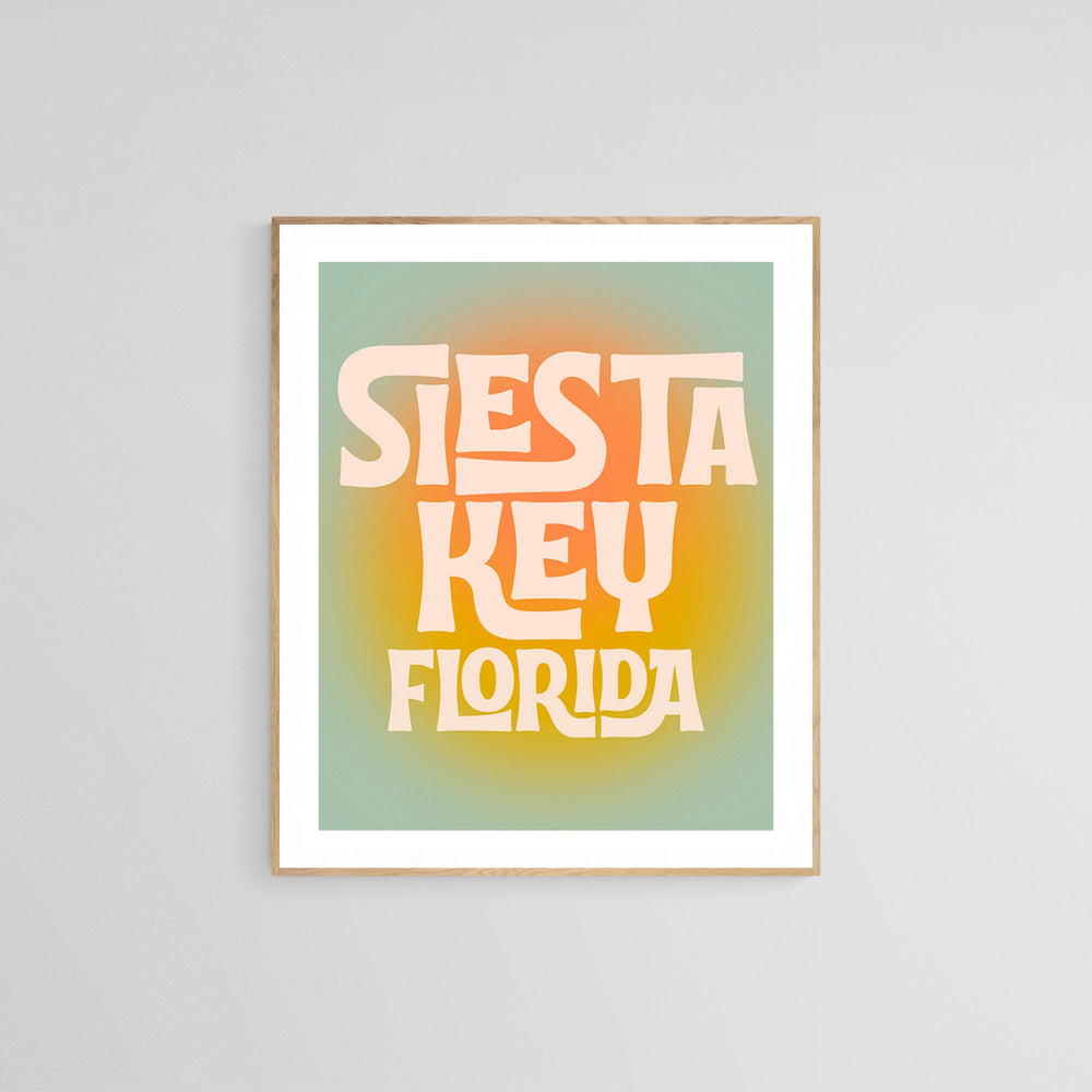 Framed modern art print with 'Siesta Key Florida' in large, stylized cream letters on a yellow-orange gradient circle against a muted teal background.