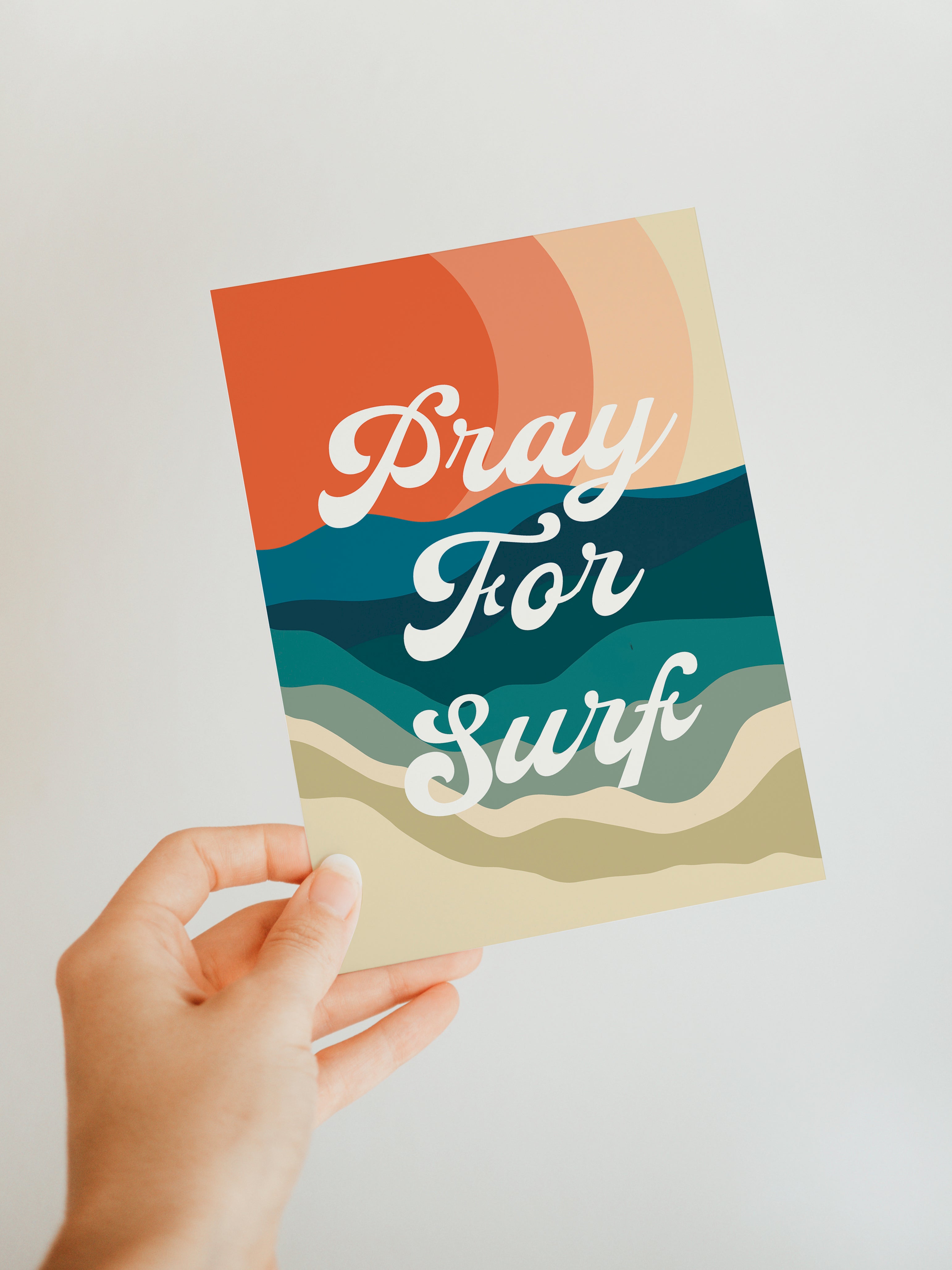 Pray For Surf blank note card featuring a coastal scene print by Alicia Bock, shown with matching envelope on a dark surface.