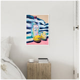 Colorful painting depicting a gin bottle, sliced lemon, and a glass with lemon wedges against a striped background, framed and hung above a wooden bedside table.