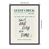 Framed wall art print resembling a guest check with teal headings and black cursive text saying 'Take it ONE DAY at a TIME' on cream background with measurement labels.
