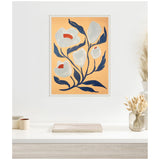 Framed canvas artwork featuring stylized gray and white flowers with red centers and dark blue leaves on a muted orange background hanging above a white tabletop with neutral decor.
