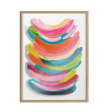 Abstract print with layered curved brushstrokes in vibrant pink, orange, blue, green, and yellow tones, accented with small white dotted patterns, in a light wood frame.