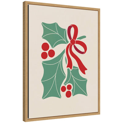 Framed canvas artwork showing stylized holly leaves, berries, and ribbon in red and green festive colors.